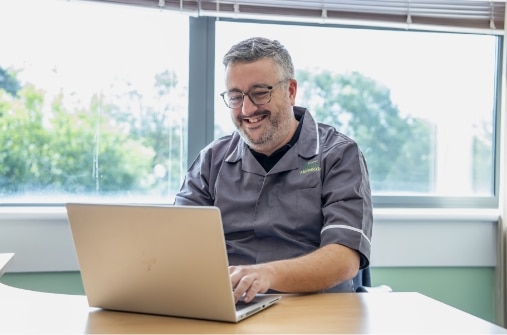 A team member learning on his laptop